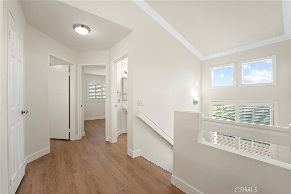 2405 Highland Pines Road Pomona, CA 91767 - Photo 26 of 32 a view of hallway with windows and wooden floor