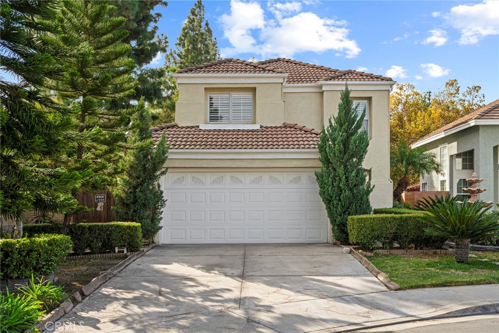 2405 Highland Pines Road Pomona, CA 91767 - Photo 3 of 32 a white house with a tree in front of it