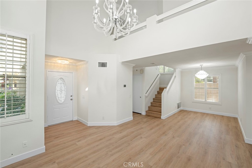 2405 Highland Pines Road Pomona, CA 91767 - Photo 9 of 32 an empty room with wooden floor and windows