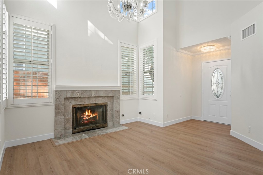 2405 Highland Pines Road Pomona, CA 91767 - Photo 10 of 32 a view of an empty room with wooden floor fireplace and a window