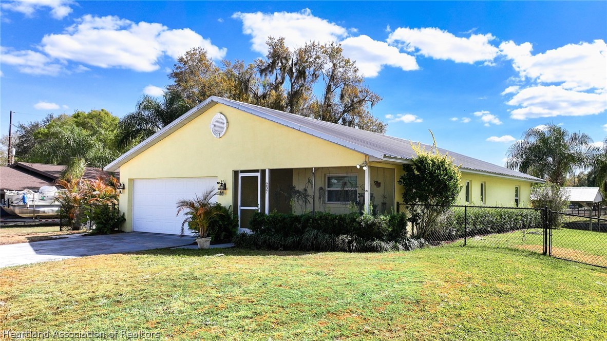 237 Wild Duck Point Lorida, FL 33857 - Photo 1 of 39 a front view of house with yard and trees in the background