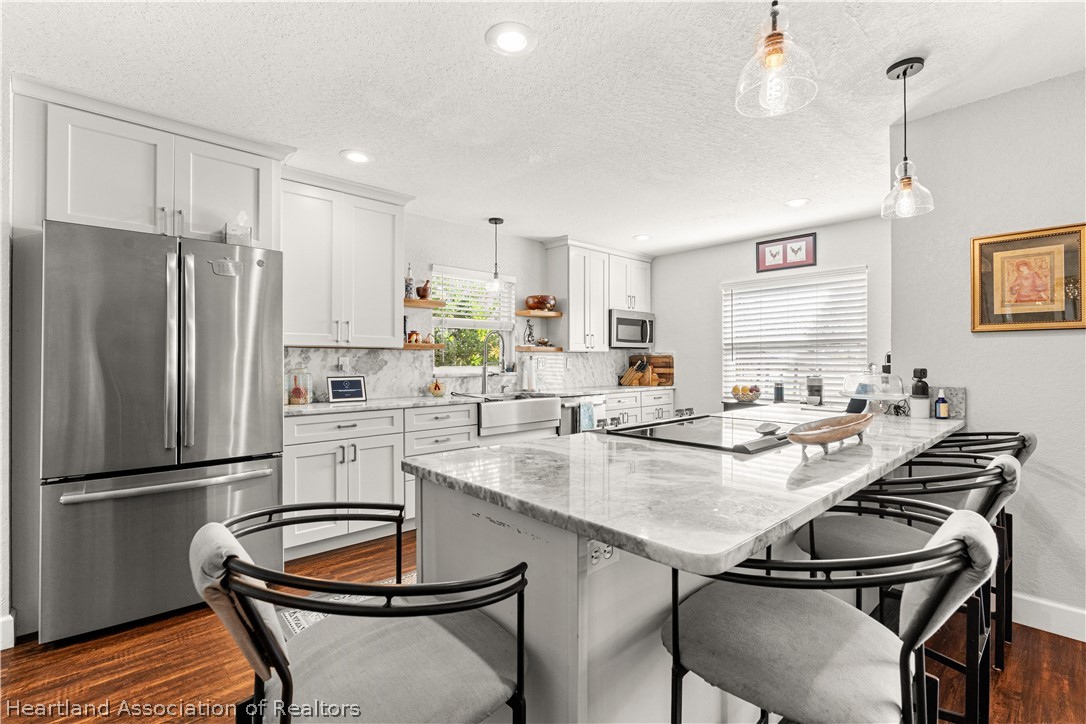 237 Wild Duck Point Lorida, FL 33857 - Photo 19 of 39 a kitchen with a dining table chairs and refrigerator