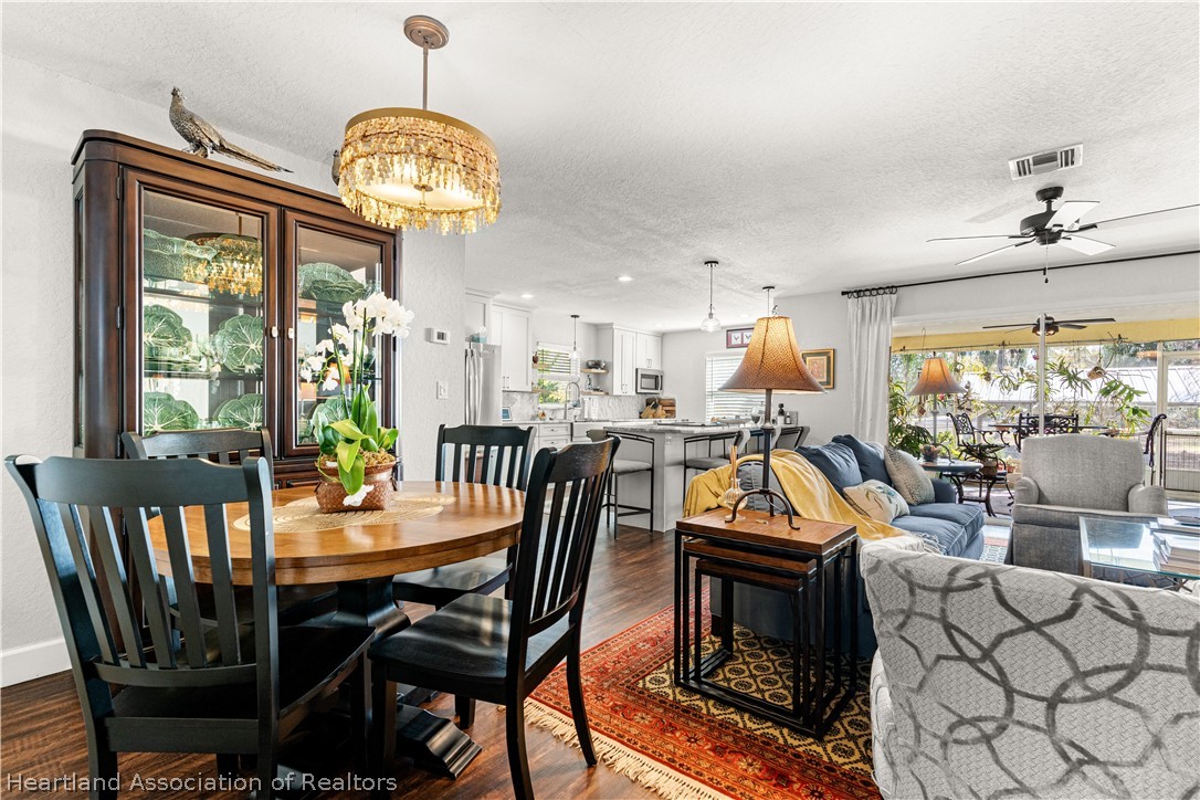 237 Wild Duck Point Lorida, FL 33857 - Photo 23 of 39 a view of a dining room with furniture a chandelier and wooden floor