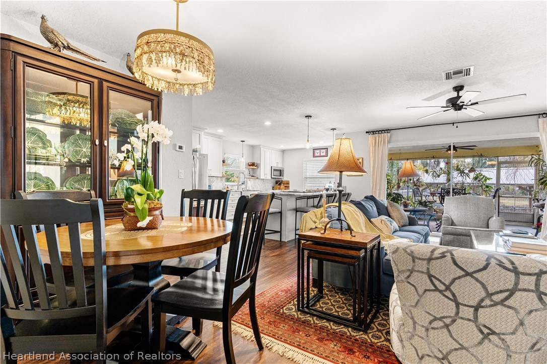 237 Wild Duck Point Lorida, FL 33857 - Photo 24 of 39 a view of a dining room with furniture wooden floor and chandelier