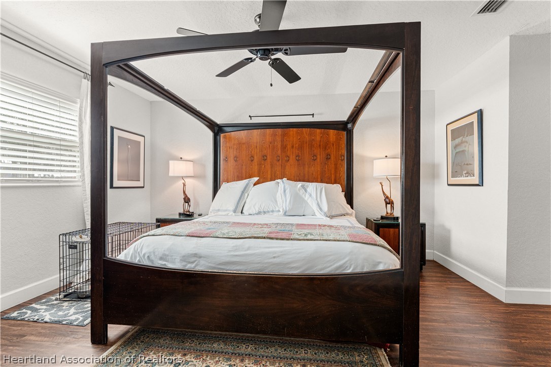 237 Wild Duck Point Lorida, FL 33857 - Photo 28 of 39 a bedroom with a bed and wooden floor