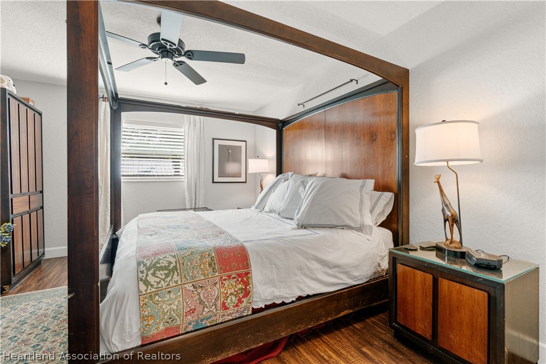237 Wild Duck Point Lorida, FL 33857 - Photo 29 of 39 a bedroom with a bed and a chandelier