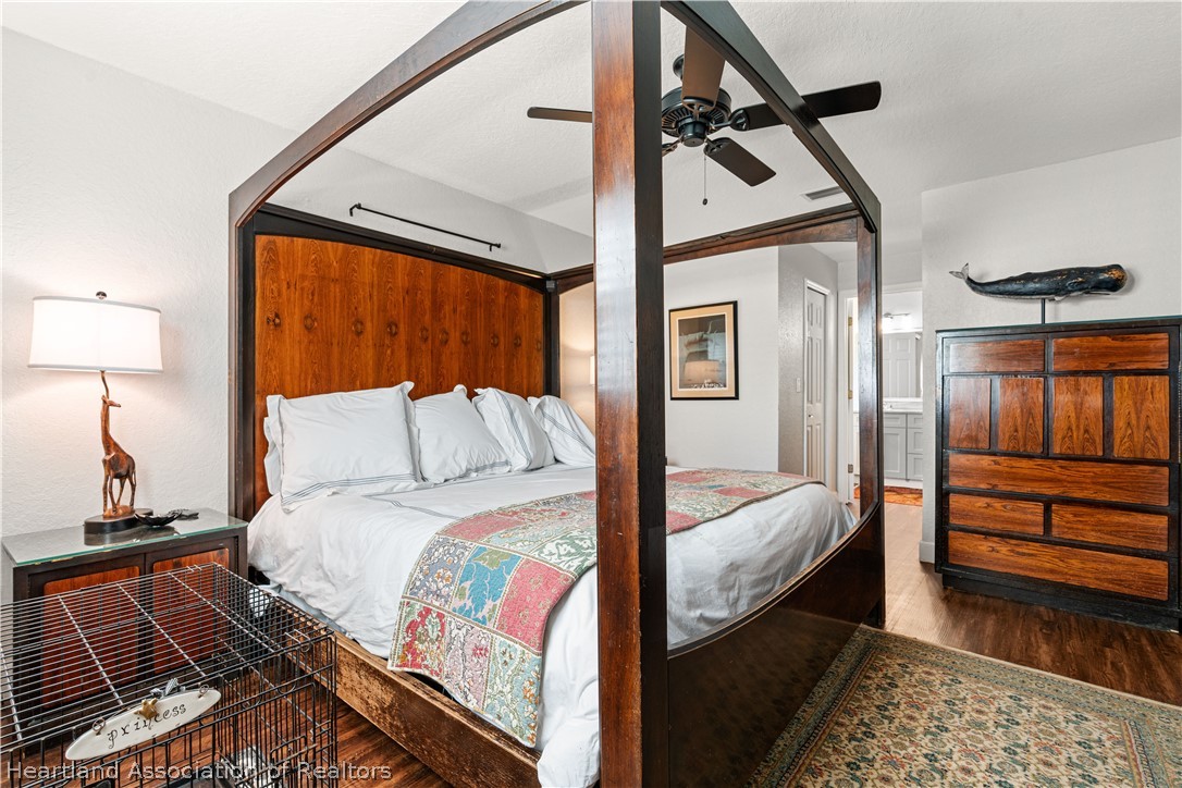 237 Wild Duck Point Lorida, FL 33857 - Photo 30 of 39 a bedroom with bed and wooden floor
