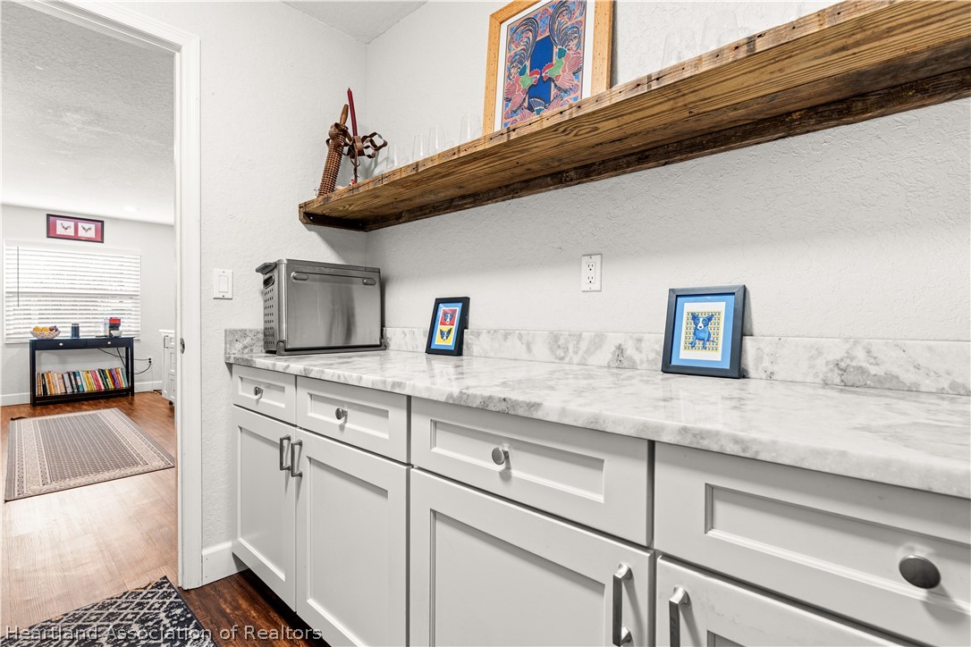 237 Wild Duck Point Lorida, FL 33857 - Photo 35 of 39 a kitchen with stainless steel appliances granite countertop a sink and cabinets