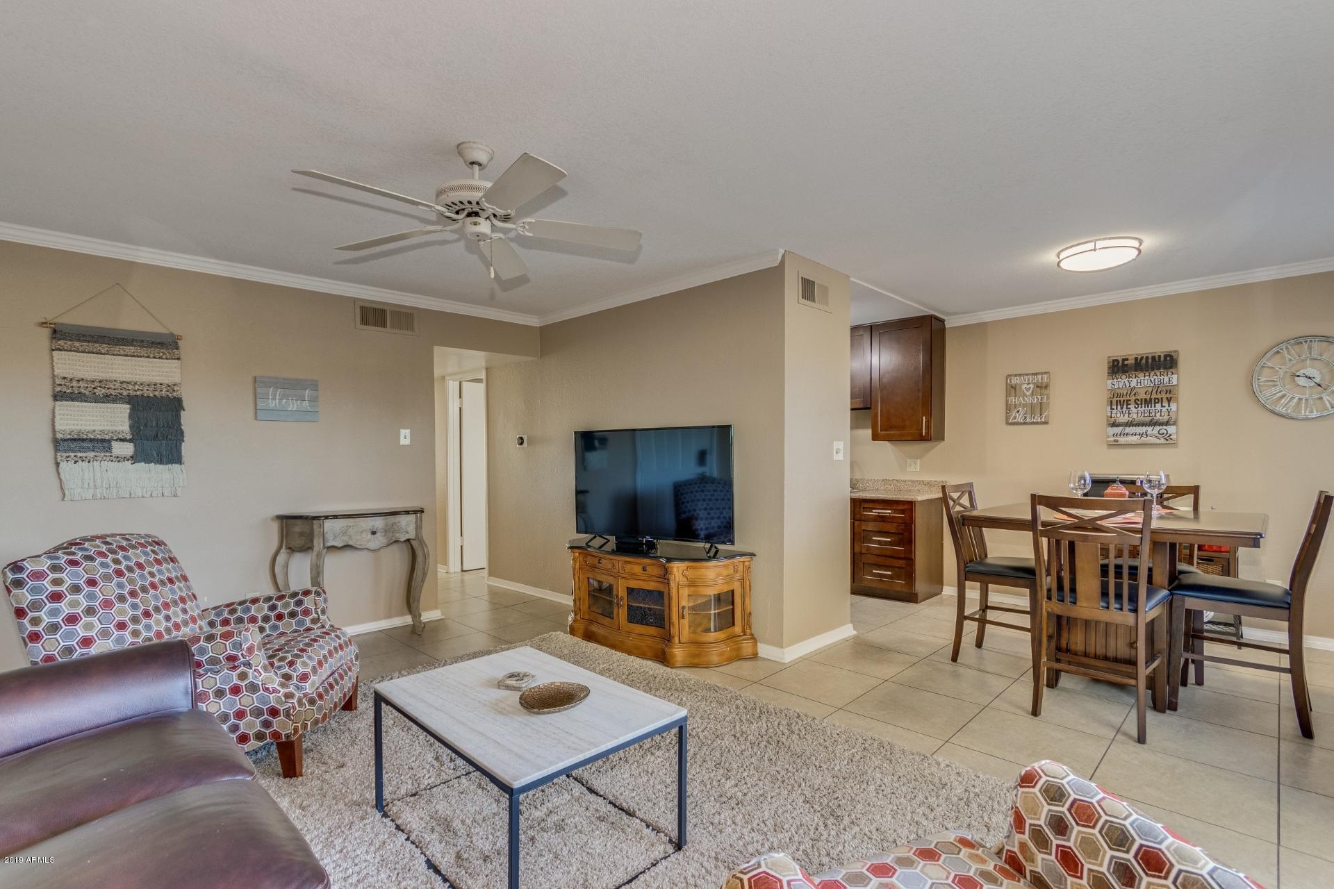 3600 North Hayden Road, Unit 2803 Scottsdale, AZ 85251 - Photo 11 of 22 a living room with furniture and a flat screen tv