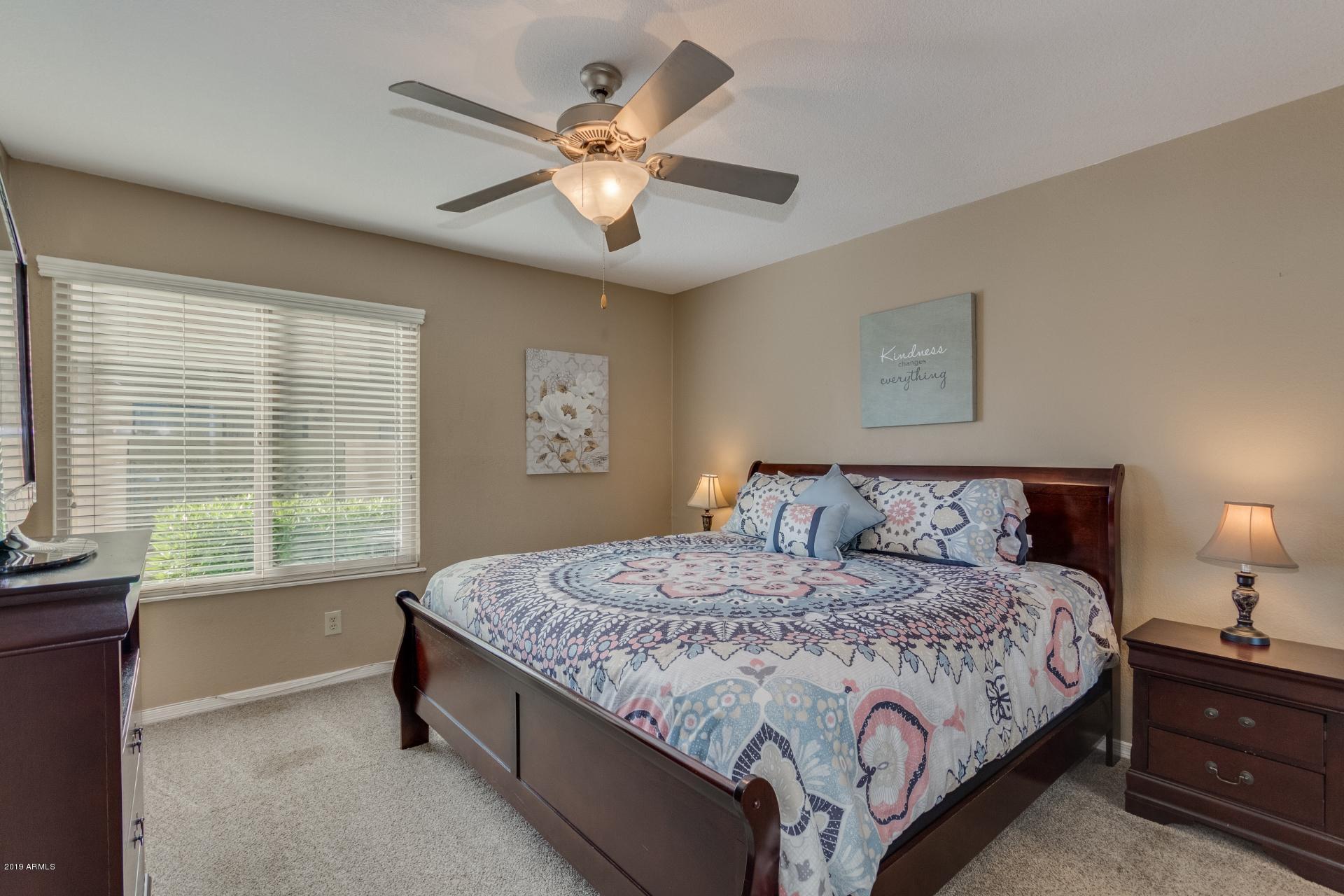 3600 North Hayden Road, Unit 2803 Scottsdale, AZ 85251 - Photo 12 of 22 a bedroom with a large bed and a chandelier