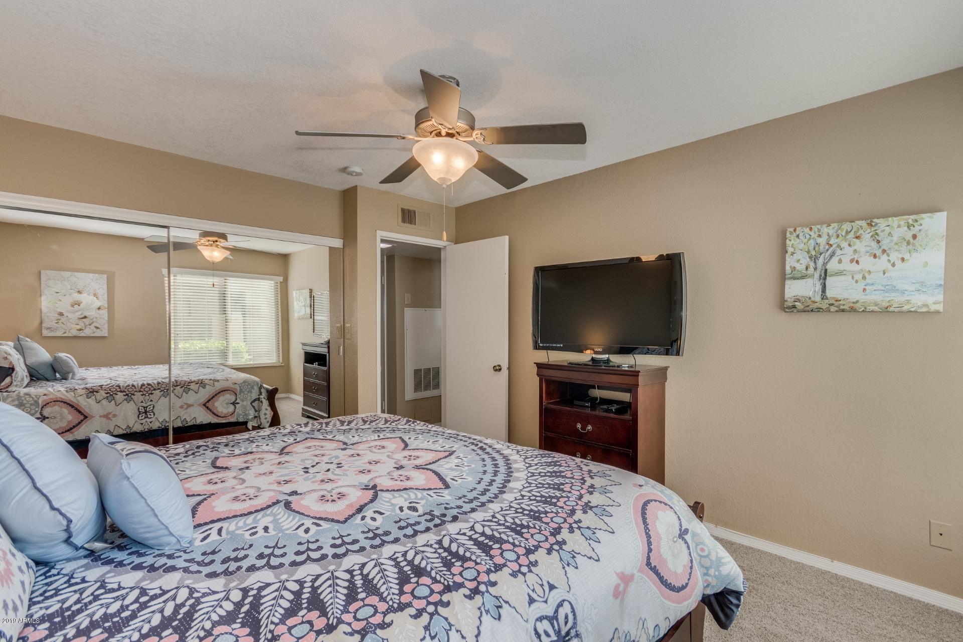 3600 North Hayden Road, Unit 2803 Scottsdale, AZ 85251 - Photo 13 of 22 a bedroom with a bed and a flat screen tv