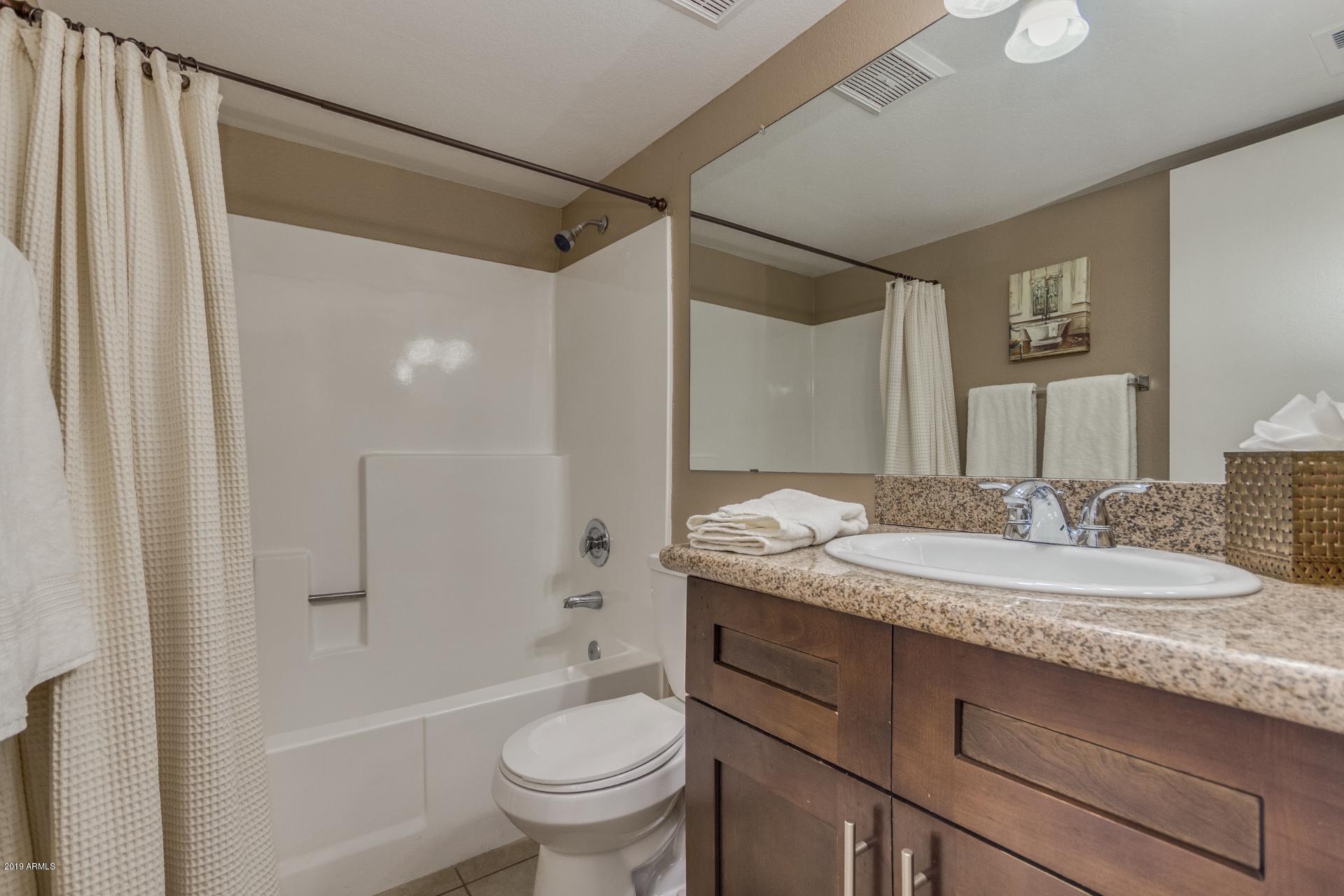 3600 North Hayden Road, Unit 2803 Scottsdale, AZ 85251 - Photo 14 of 22 a bathroom with a granite countertop sink toilet and shower