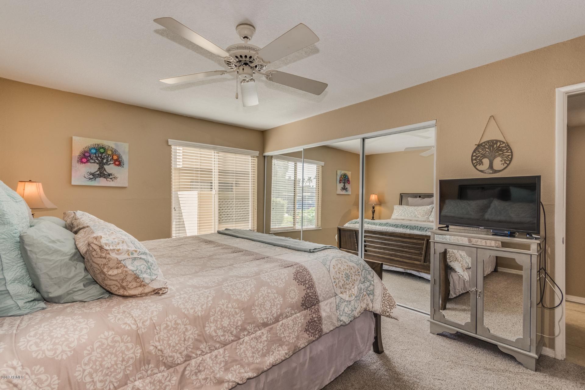 3600 North Hayden Road, Unit 2803 Scottsdale, AZ 85251 - Photo 16 of 22 a bedroom with a large bed a flat tv screen and dresser