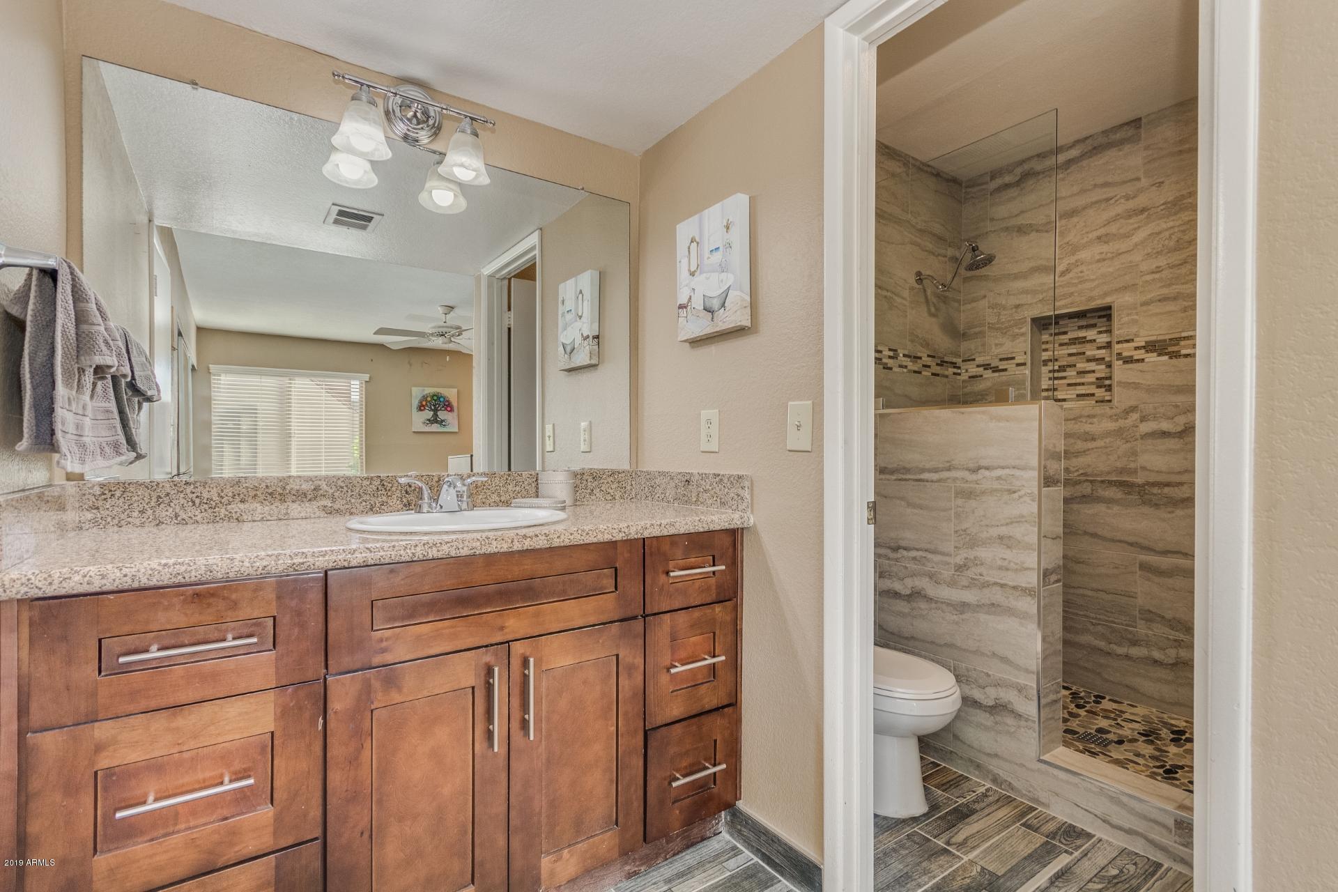 3600 North Hayden Road, Unit 2803 Scottsdale, AZ 85251 - Photo 17 of 22 a bathroom with a granite countertop sink toilet and shower