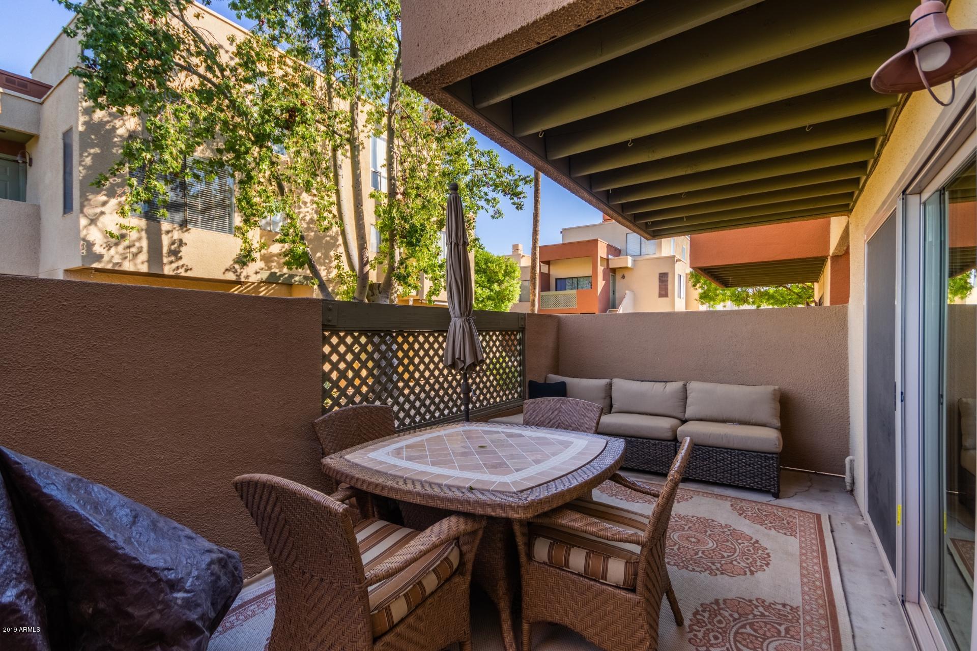 3600 North Hayden Road, Unit 2803 Scottsdale, AZ 85251 - Photo 19 of 22 a backyard of a house with table and chairs