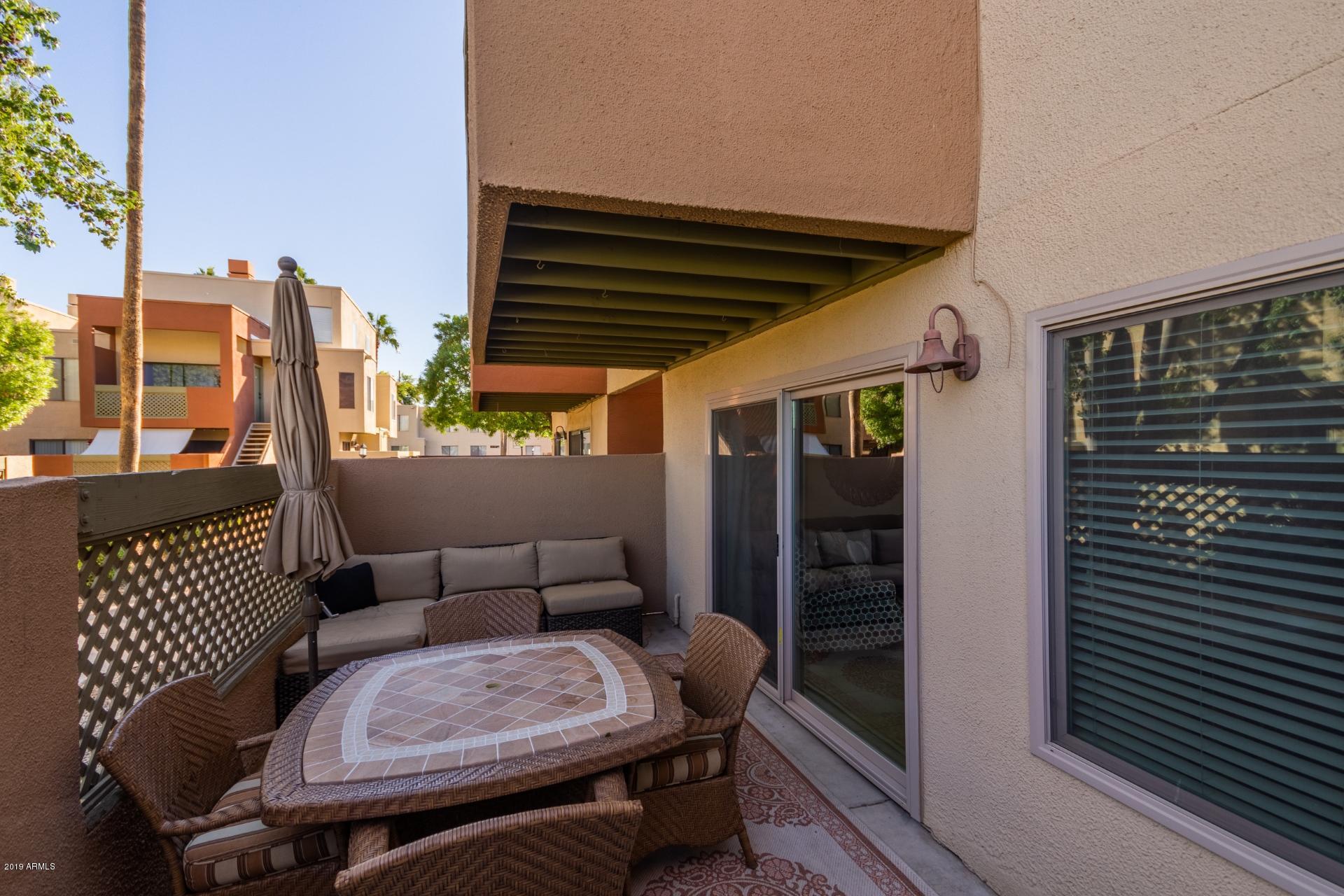 3600 North Hayden Road, Unit 2803 Scottsdale, AZ 85251 - Photo 20 of 22 a balcony with table and chairs