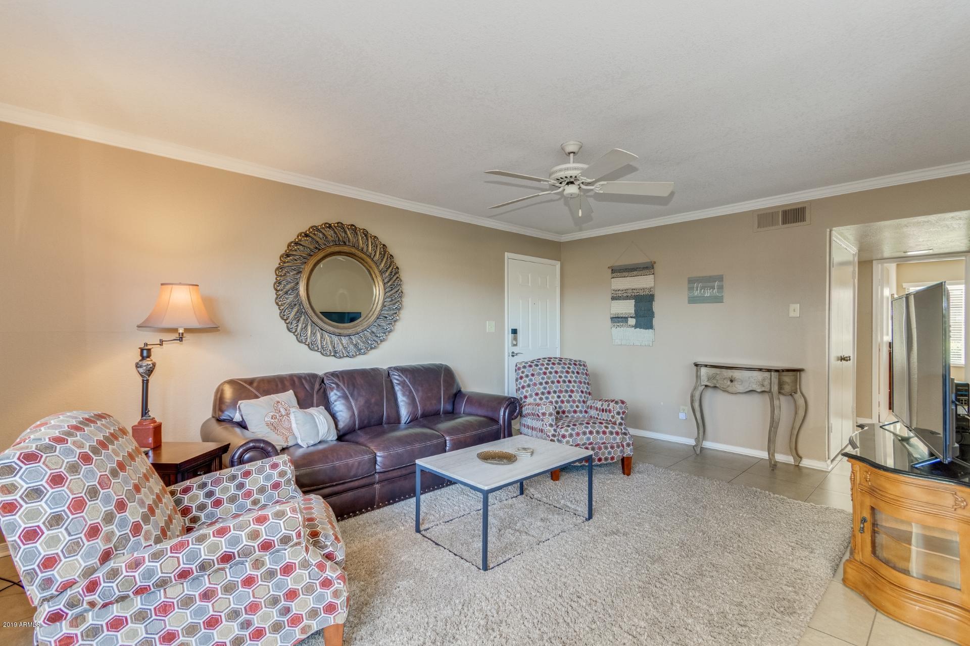 3600 North Hayden Road, Unit 2803 Scottsdale, AZ 85251 - Photo 2 of 22 a living room with furniture a rug and a lamp