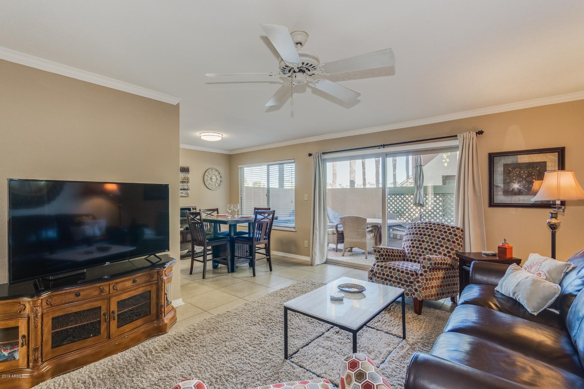 3600 North Hayden Road, Unit 2803 Scottsdale, AZ 85251 - Photo 3 of 22 a living room with furniture and a flat screen tv