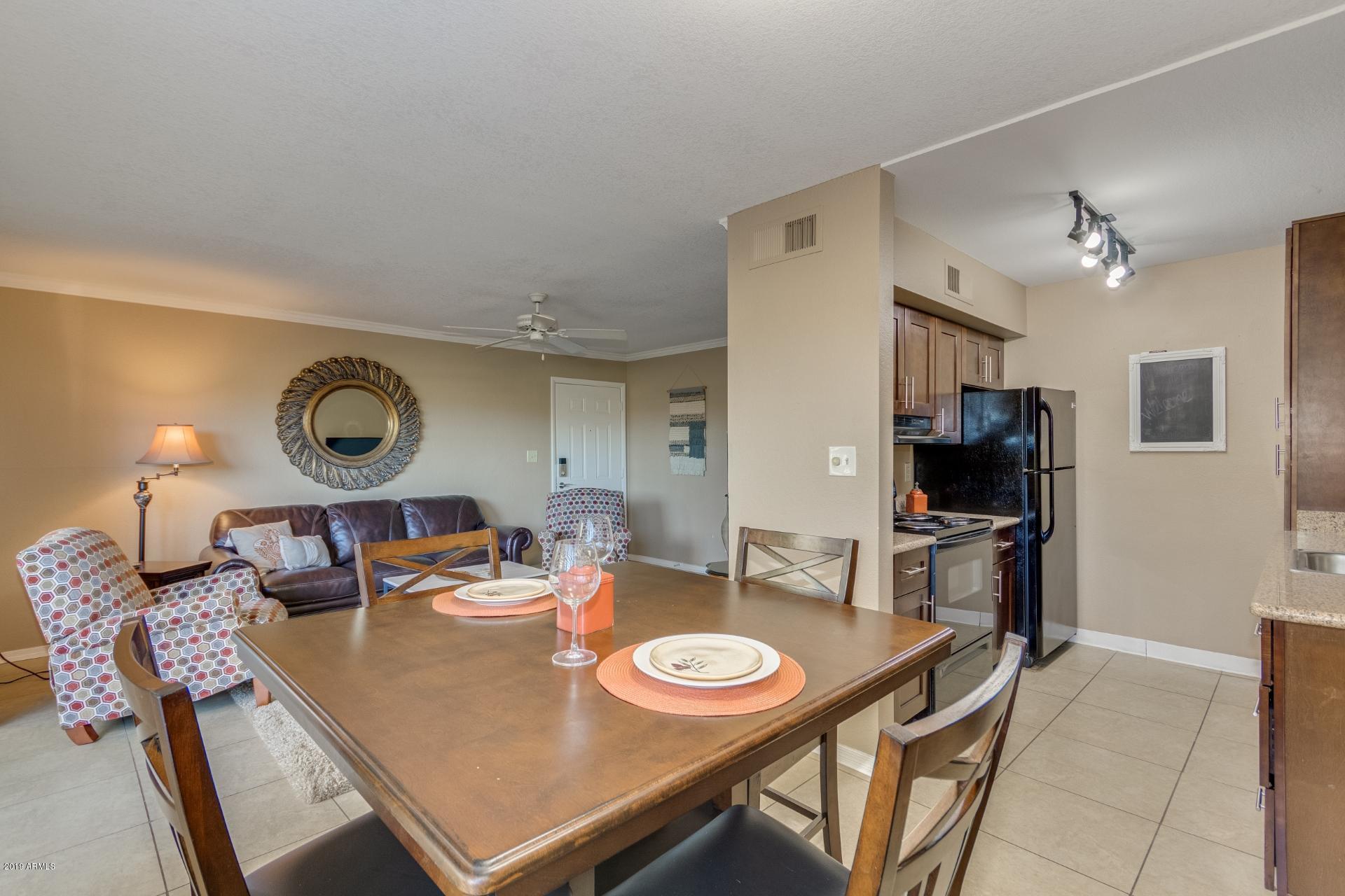 3600 North Hayden Road, Unit 2803 Scottsdale, AZ 85251 - Photo 6 of 22 a view of a dining room with furniture and a chandelier