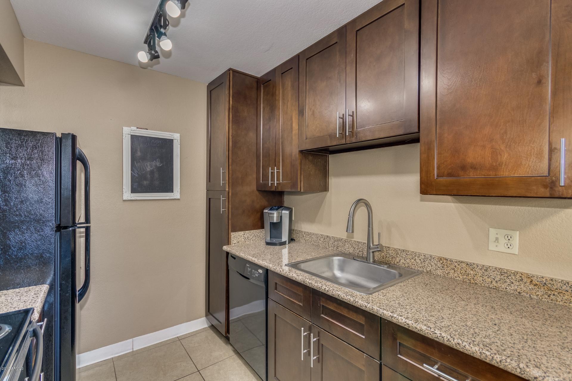 3600 North Hayden Road, Unit 2803 Scottsdale, AZ 85251 - Photo 8 of 22 a kitchen with granite countertop stainless steel appliances a sink stove and refrigerator