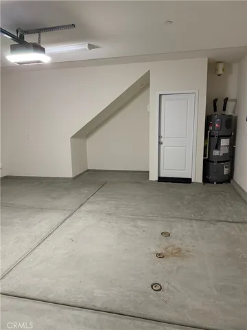 a view of a patio with chairs under an umbrella