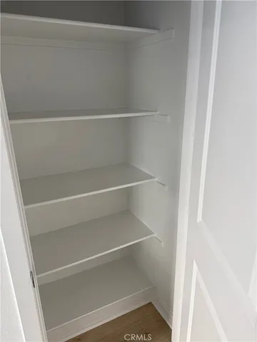 a view of walk in closet with empty racks
