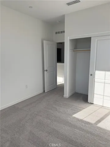 a view of an empty room with a closet