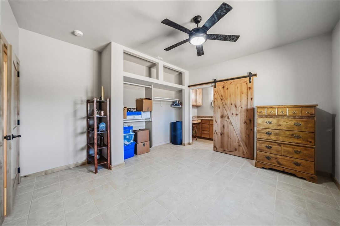10374 East Happy Trails Road Kingman, AZ 86401 - Photo 33 of 68 a view of a livingroom with a furniture closet and a ceiling fan
