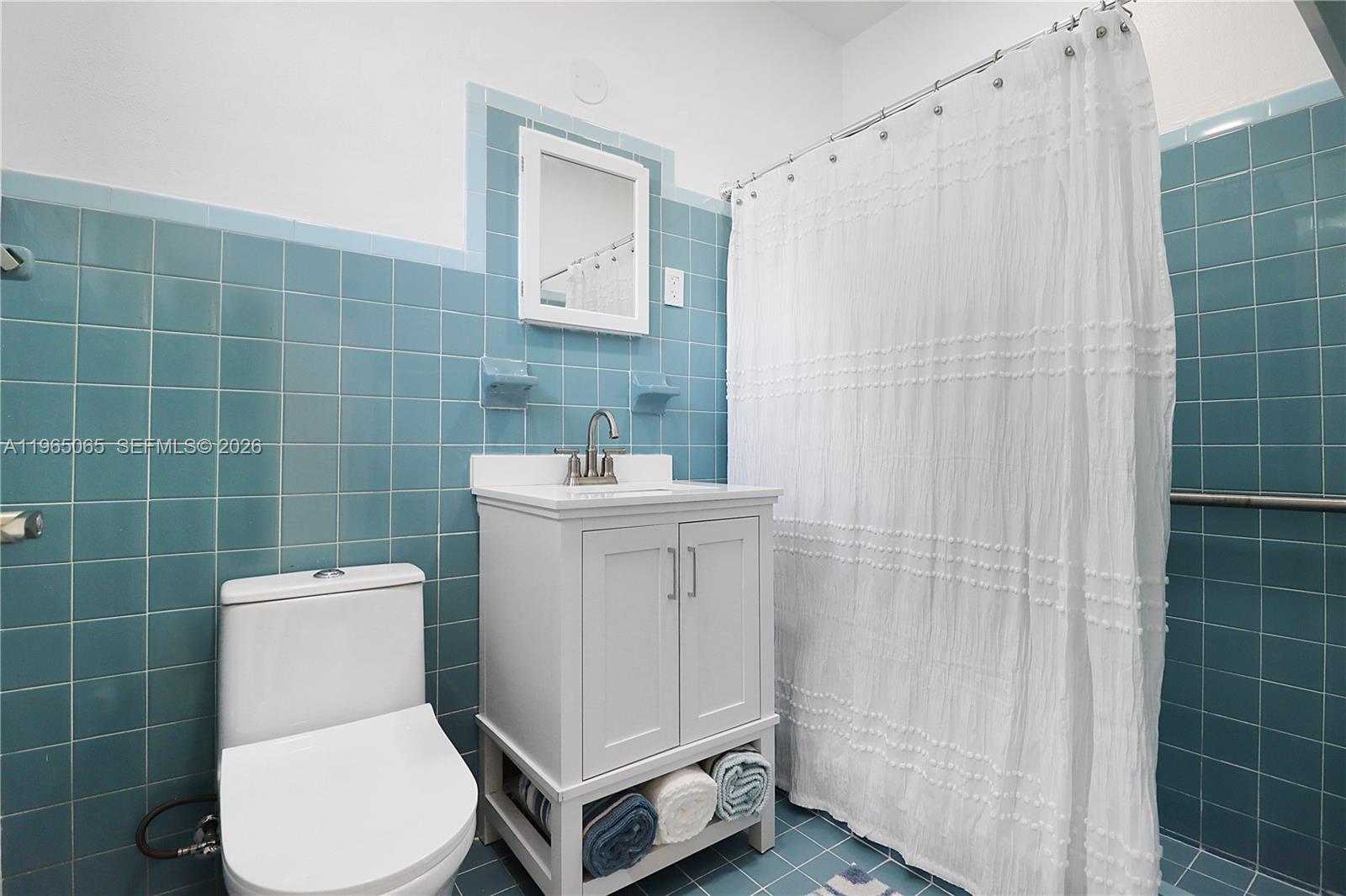 3330 Southwest 2nd Street Miami, FL 33135 - Photo 17 of 28 a bathroom with a toilet sink and shower