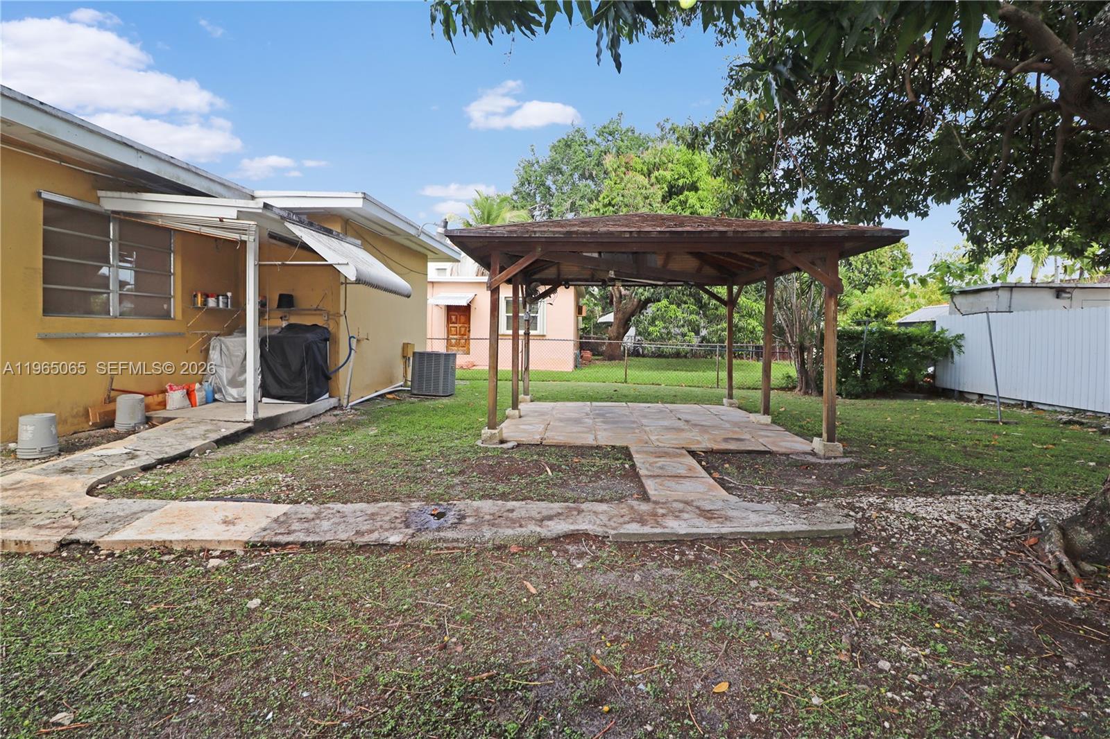 3330 Southwest 2nd Street Miami, FL 33135 - Photo 25 of 28 a view of a house with backyard and a tree