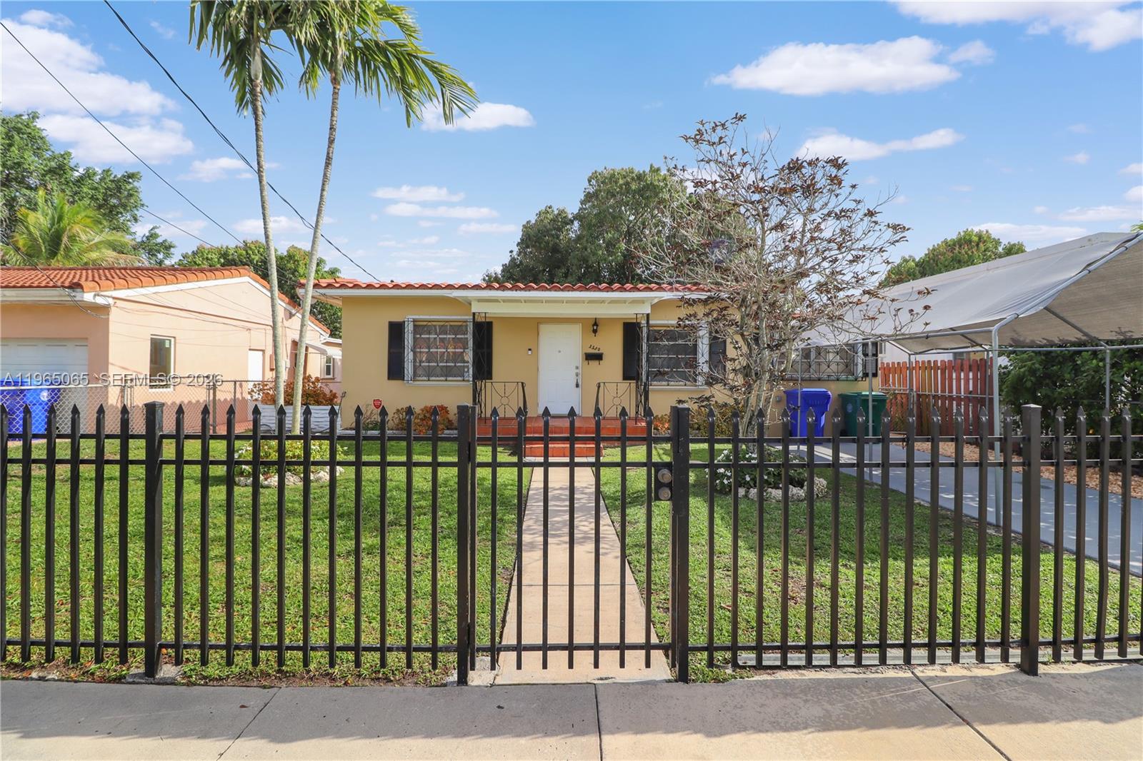 3330 Southwest 2nd Street Miami, FL 33135 - Photo 28 of 28 a view of a white building that has a tree in it
