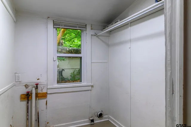 a bathroom with a window and a shower