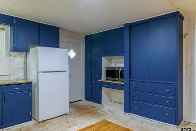 a kitchen with a refrigerator and a stove
