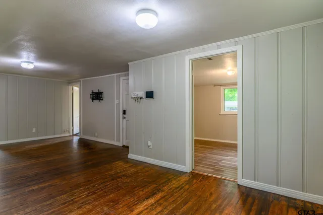 an empty room with wooden floor and closet