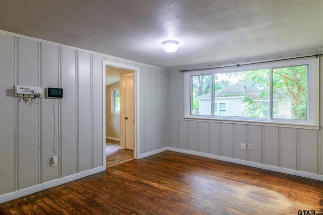a view of a room with wooden floor and natural light