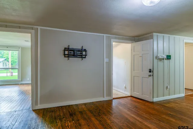 a view of an empty room with wooden floor