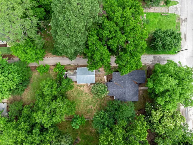 an aerial view of a house with a yard