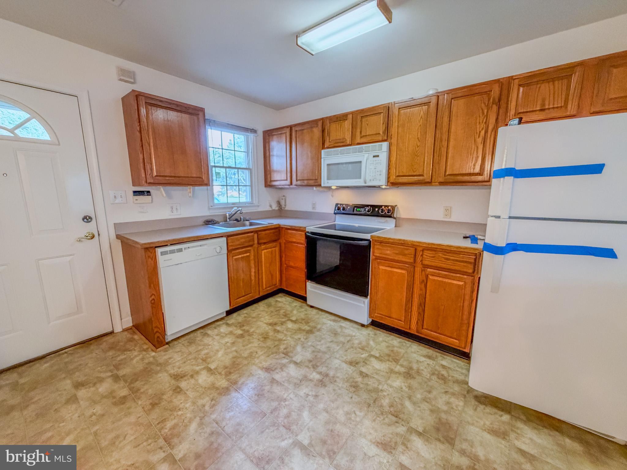 23 East Village Road Newark, DE 19713 - Photo 3 of 11 a kitchen with stainless steel appliances granite countertop a stove sink and cabinets