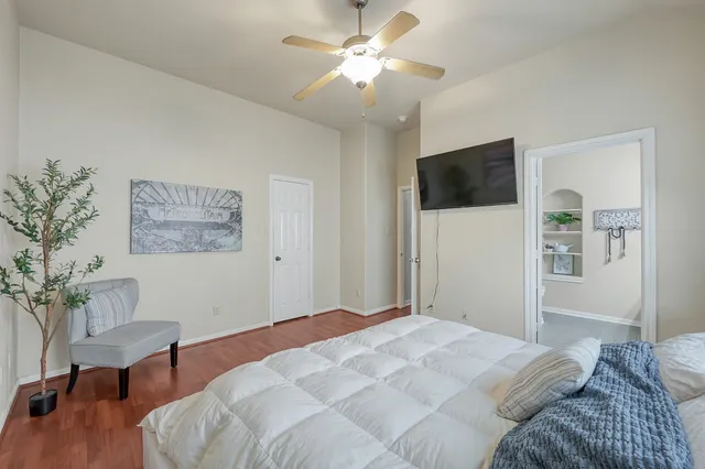 a bedroom with a large bed and a tv