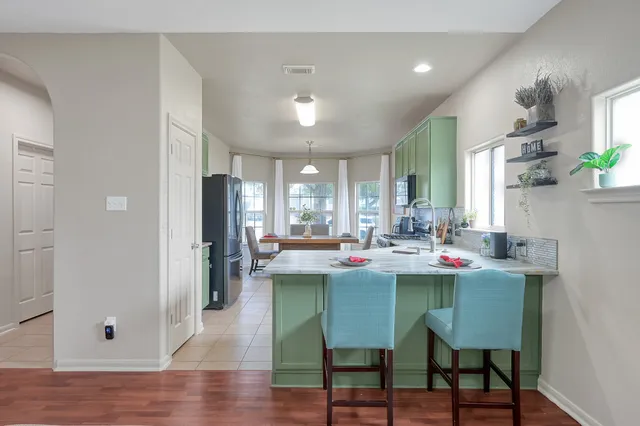 a view of a dining room with furniture and wooden floor