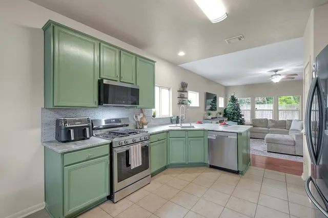 a kitchen with stainless steel appliances granite countertop a sink and stove top oven with granite countertops
