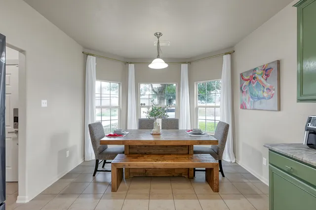 a dining room with furniture and window