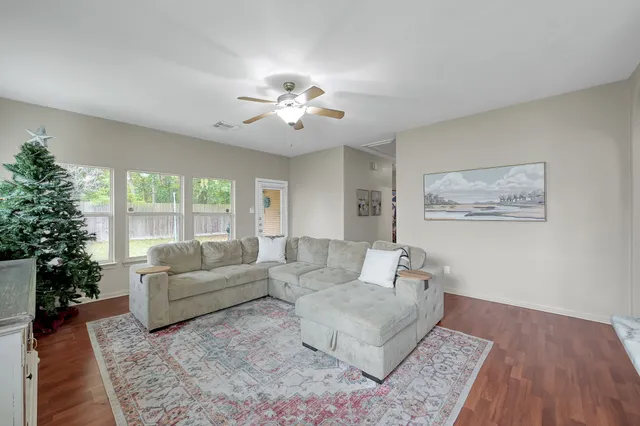 a living room with furniture and a large window