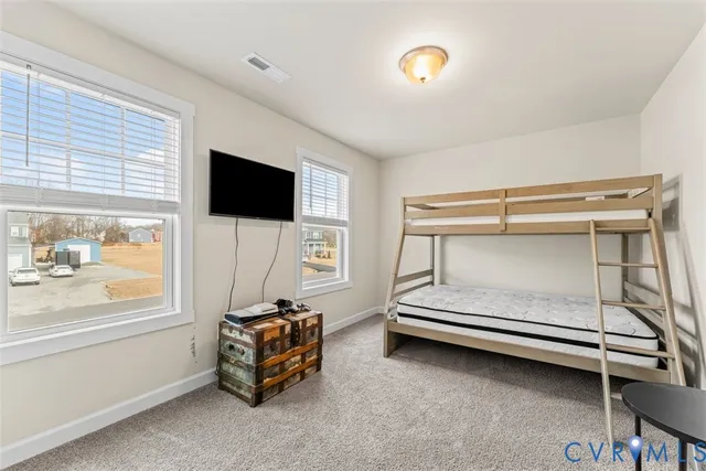 a bedroom with furniture and a flat screen tv