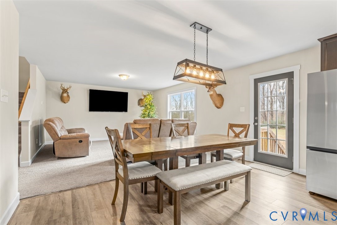 1463 Tutelo Road Quinton, VA 23141 - Photo 3 of 31 a dining room with furniture a chandelier and wooden floor