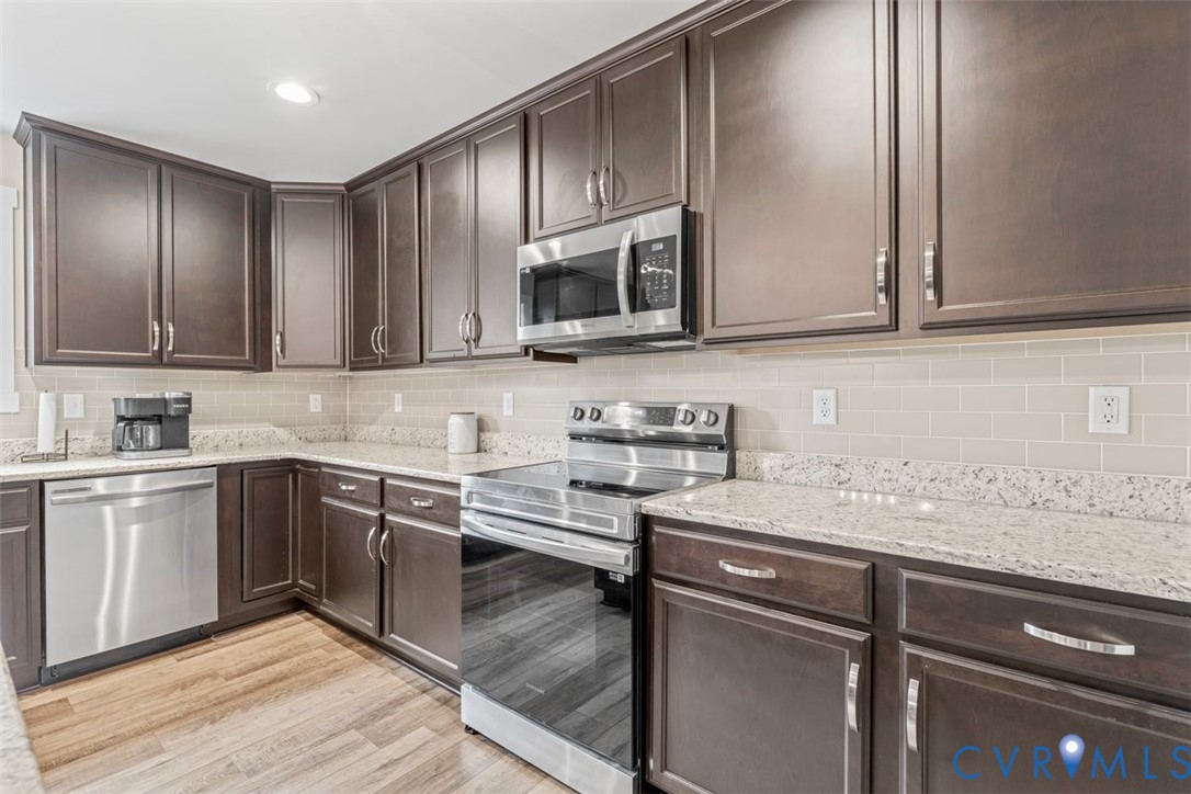 1463 Tutelo Road Quinton, VA 23141 - Photo 4 of 31 a kitchen with stainless steel appliances granite countertop a sink stove and microwave