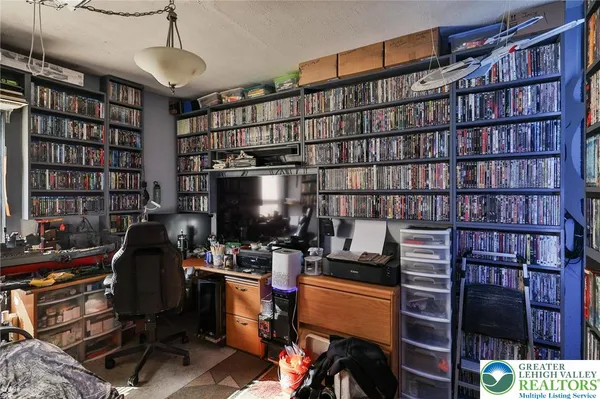 a work room with furniture and book shelf