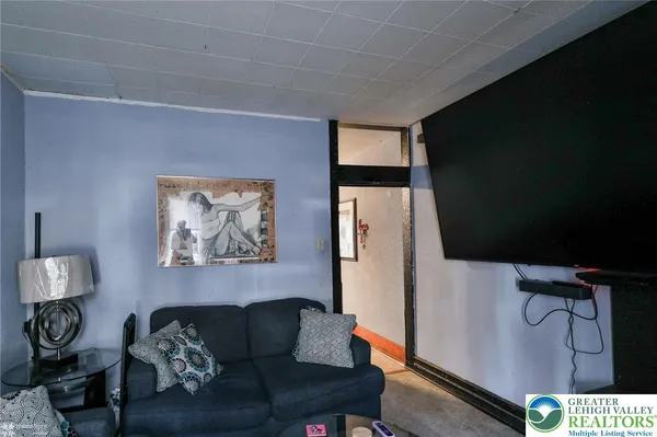 a living room with furniture and a lamp