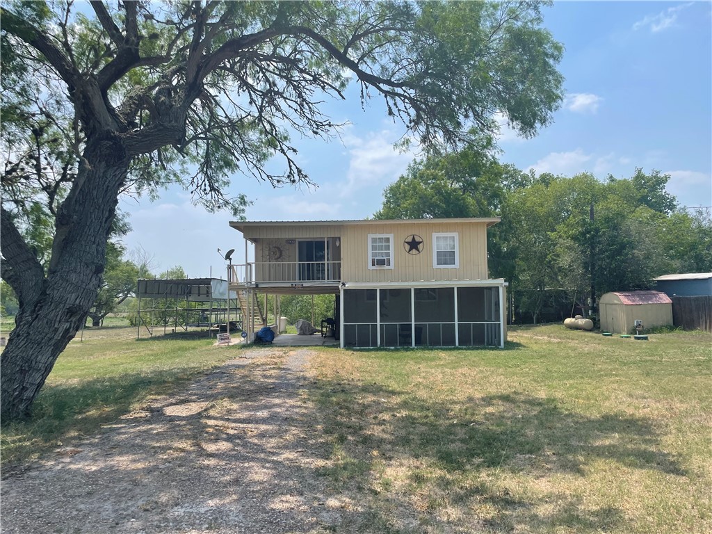 a view of a house with a yard and sitting area