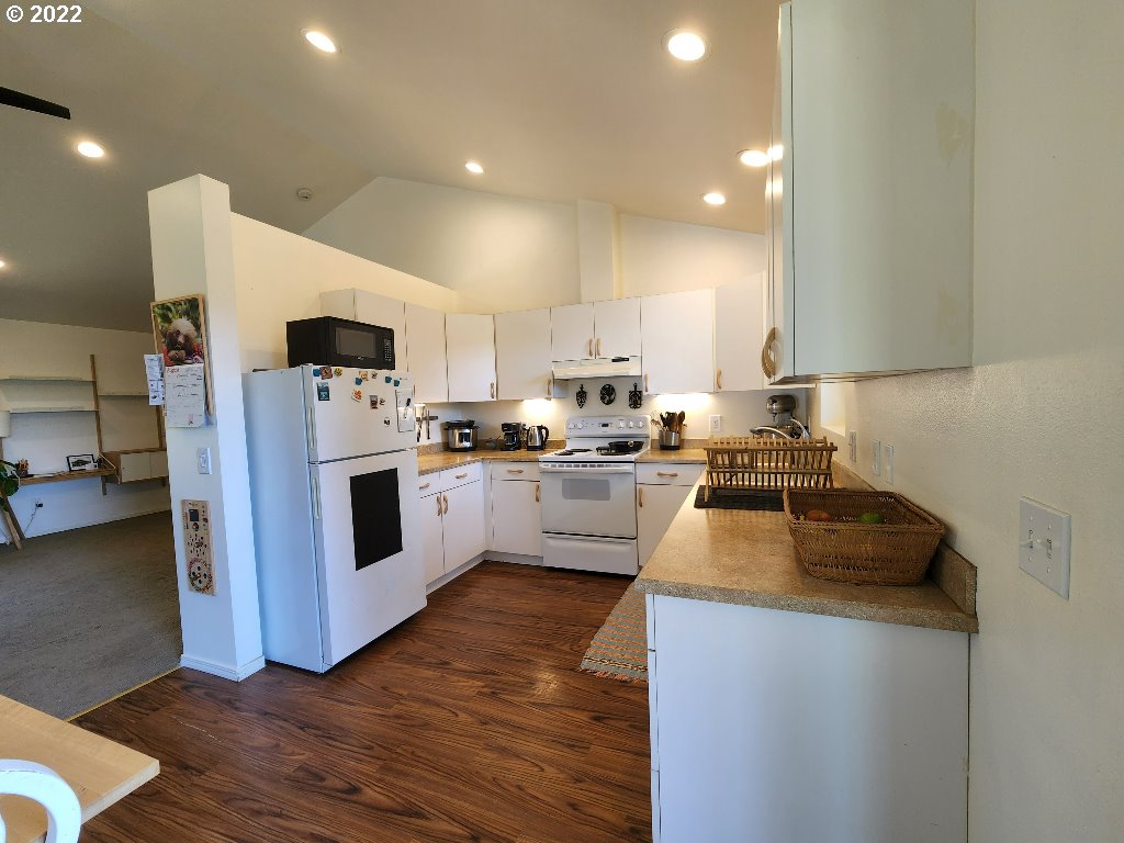 23 Wnuk Road White Salmon, WA 98672 - Photo 14 of 25 a kitchen with white cabinets and white appliances